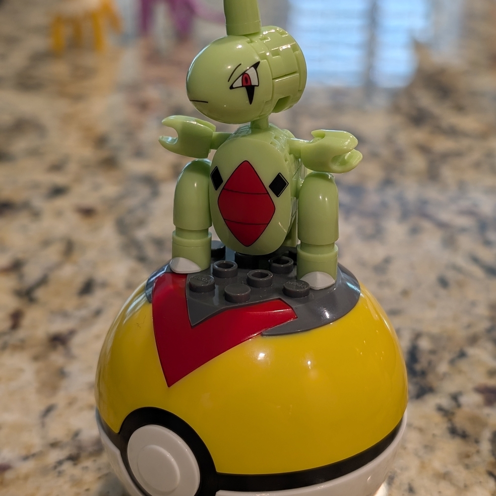 Green and Yellow Building Toy with Poké Ball